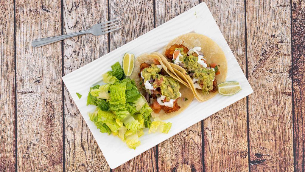 Baja Tacos · 2 tacos with pickled coleslaw, pico de gallo, guacamole,and sour cream with a side salad vinaigrette.