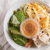 Roxie House Salad · Artichoke hearts, tomato, onion, marinated mushrooms, four bean salad and avocado on a bed o...