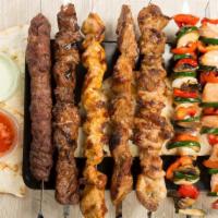 Chicken and Lamb Kabob Plate · Chicken and Lamb kabob served with a side of rice, hummus, Greek salad, and fresh pita bread...