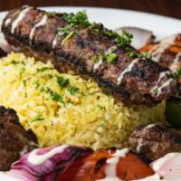 Kefta Kabob Plate · Kefta kabob served with a side of rice, hummus, Greek salad, and fresh pita bread along with...