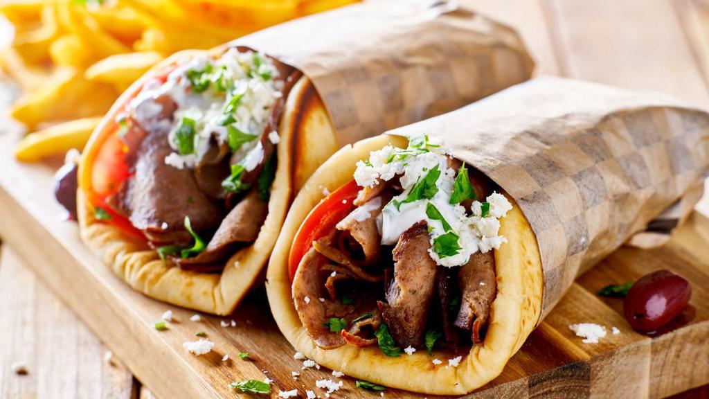 Lamb Gyro · Thin marinated slices of lamb gyro meat, lettuce, tomatoes, onions topped with tzatziki sauce on a thick pita bread.
