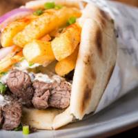 Steak Gyro · Thin marinated slices of steak gyro meat, lettuce, tomatoes, onions topped with tzatziki sau...