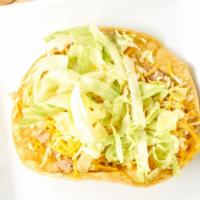 Beans Tostada · Crunchy corn tortilla topped with refried beans, and lettuces cheese.