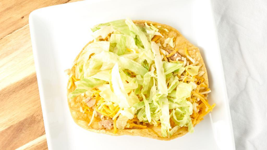 Beans Tostada · Crunchy corn tortilla topped with refried beans, and lettuces cheese.