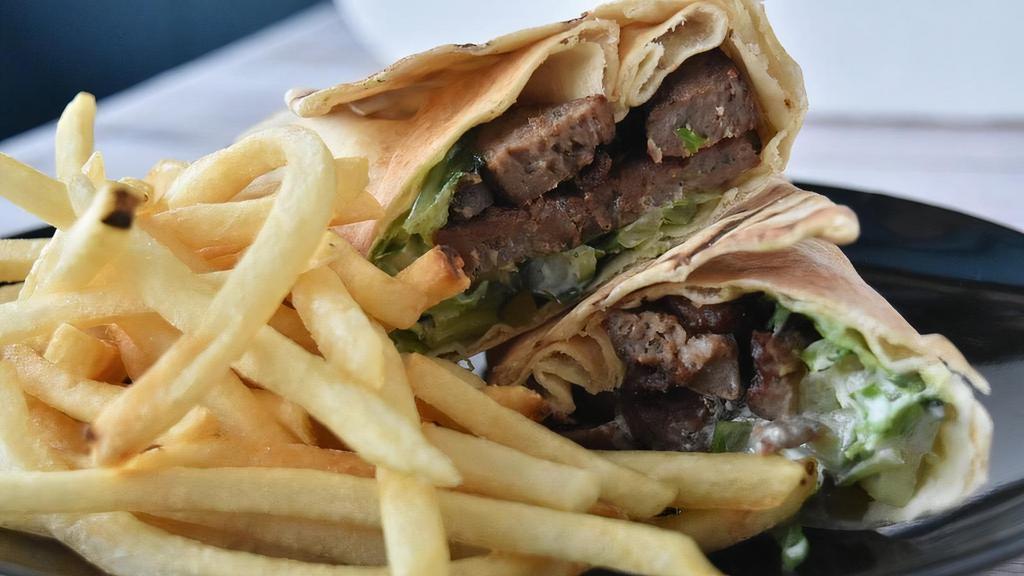 Gyro Wrap · Sliced lamb & beef gyro served in Lebanese bread with lettuce, pickles, and Tzatziki.