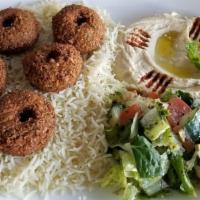 Falafel Plate · 5 pieces of crispy falafel served on a bed of rice alongside a serving of house salad, hummu...