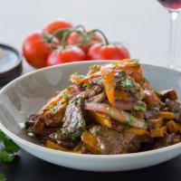Lomo Saltado   · Beef tenderloin, red onion, tomato, shoyu, cilantro with a choice of rice/french fries or be...