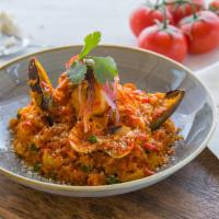 Arroz con mariscos · Variety of seafood and rice cooked with Peruvian dressing and seafood broth