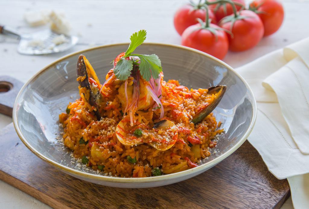 Arroz con mariscos · Variety of seafood and rice cooked with Peruvian dressing and seafood broth
