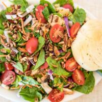 Spinach Salad · Fresh spinach leaves mixed with red onions, button mushrooms, carrots, artichoke hearts, gra...