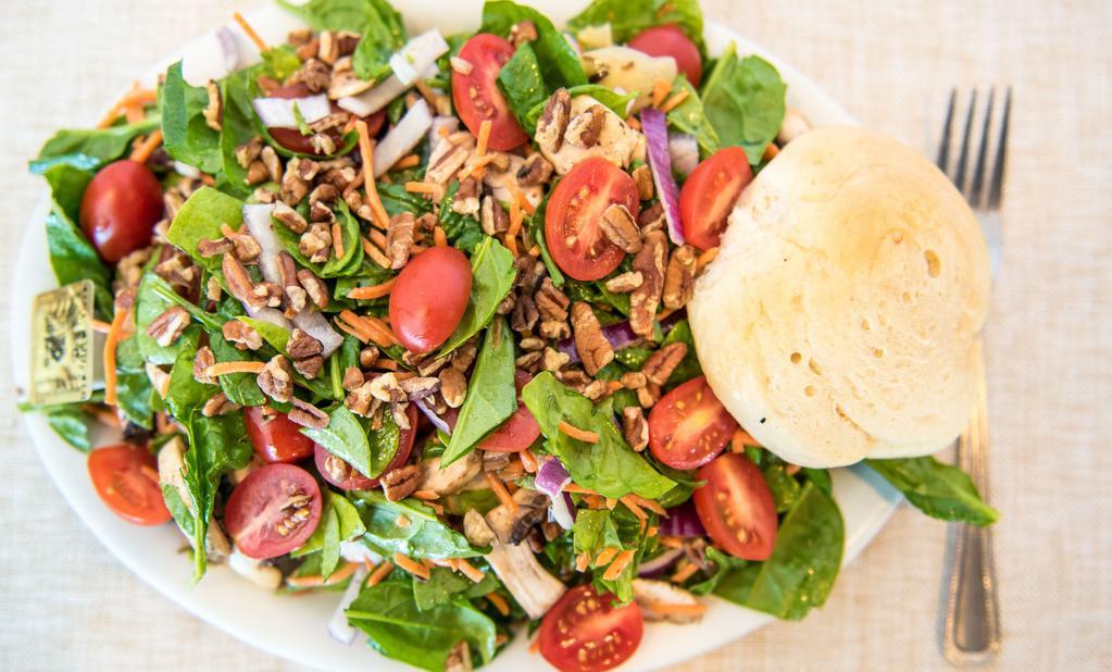 Spinach Salad · Fresh spinach leaves mixed with red onions, button mushrooms, carrots, artichoke hearts, grape tomatoes, and pecans, tossed with delicious honey mustard dressing.