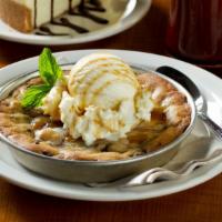 Cookieza · House baked chocolate chip cookie topped with vanilla ice cream and caramel sauce