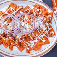 Chilaquiles · Chorizo, red or green sauce, corn tortilla chips topped with two scrambled eggs, red onions,...