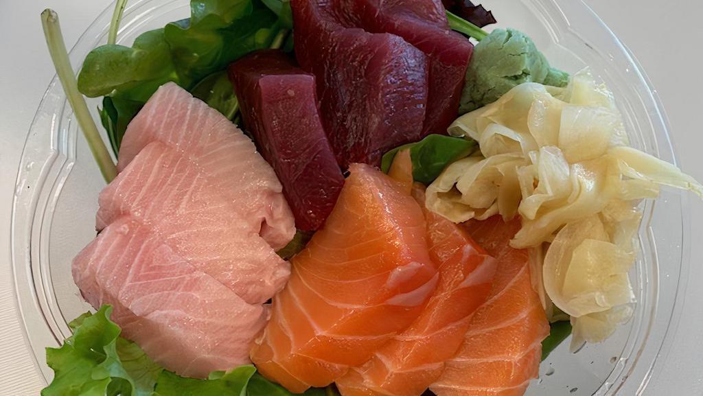 Combination Sashimi (9 Pieces) · Tuna, Salmon and Hamachi (Yellow Tail) Sashimi with sushi rice.