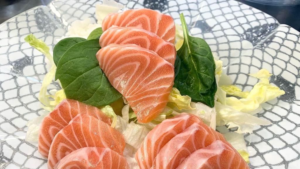 Salmon Sashimi (9 Pieces) · Sliced Salmon Sashimi with sushi rice.