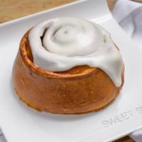 Large Cinnamon Bun · Soft and gooey, freshly baked palm size cinnamon bun topped with a delicious and light cream...