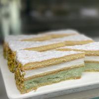 Pistachio Ricotta Mousse Cake Slice · Indulge in this light and creamy pistachio mousse / ricotta mousse layered cake with pistach...