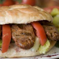 Kofte Sandwich · Charbroiled, minced lamb and beef with mixed salad, onions tomatoes, and taziki sauce.