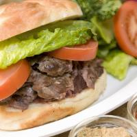 Lamb & Beef Doner Sandwich · Tender, thinly sliced marinated lamb and beef roasted in upright grill.