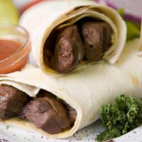 Lamb Skewer Wrap · Tendered, broiled, marinated thin lamb shish wrapped in lavash bread with mixed salad, onion...