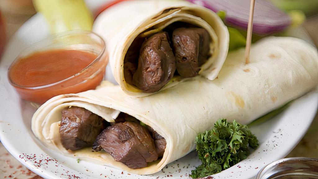 Lamb Skewer Wrap · Tendered, broiled, marinated thin lamb shish wrapped in lavash bread with mixed salad, onions, tomatoes, and taziki sauce