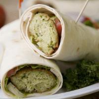 Falafel Wrap · Fried chickpea balls wrapped in lavash bread with taziki sauce, mixed salad, onions, tomatoes.