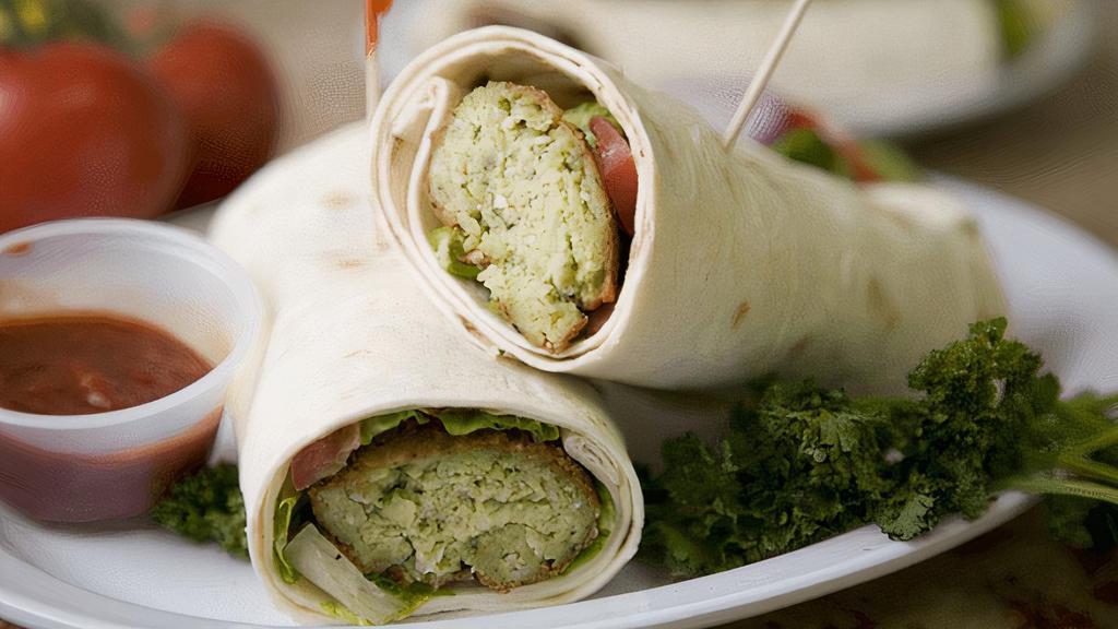 Falafel Wrap · Fried chickpea balls wrapped in lavash bread with taziki sauce, mixed salad, onions, tomatoes.