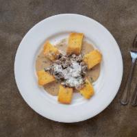 Crispy Polenta · Deep-fried polenta diamonds with sautéed wild mushrooms in a marsala cream sauce topped with...