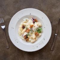Gorgonzola Gnocchi · Tossed in a Gorgonzola cream sauce with spinach, radicchio, and toasted walnuts