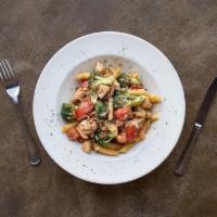 Penne Chicken · Broccoli, tomatoes, and a dash of chili flakes tossed in a browned garlic sauce, sprinkled w...