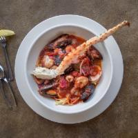 Mio Cioppino · Calamari, mussels, crab legs, prawns, peppers and fresh tomatoes in a red wine sauce on a be...