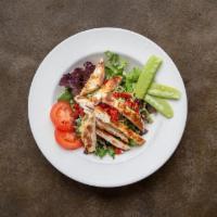 Grilled Chicken Salad · Grilled chicken breast on a bed of pesto Cappellini pasta and mixed greens with sun-dried to...