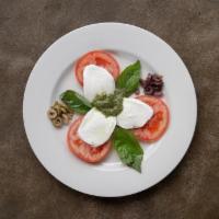 Caprese Salad · Garden tomatoes, thick sliced mozzarella, green and kalamata olives, fresh basil olive oil a...