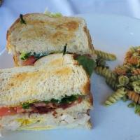 Clubhouse Sandwich · Chicken, bacon, fried egg, lettuce, tomato, mayonnaise and mustard in three stacks of bread....