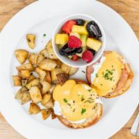 Eggs Benedict · Poached  eggs and Canadian bacon on a toasted brioche bun with Hollandaise hot sauce and ser...