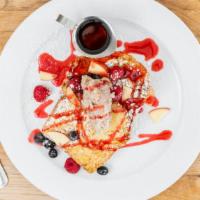 Brioche French Toast · Our famous brioche bread dipped in vanilla custard and served with raspberry coulis and seas...