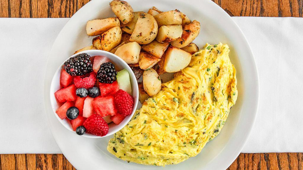 Fine-Herbs Omelet · Mixture of herbs , thyme and rosmery . served with oven roasted rosemary potatoes and mix fruit 
 Add bacon or chicken apple sausage.