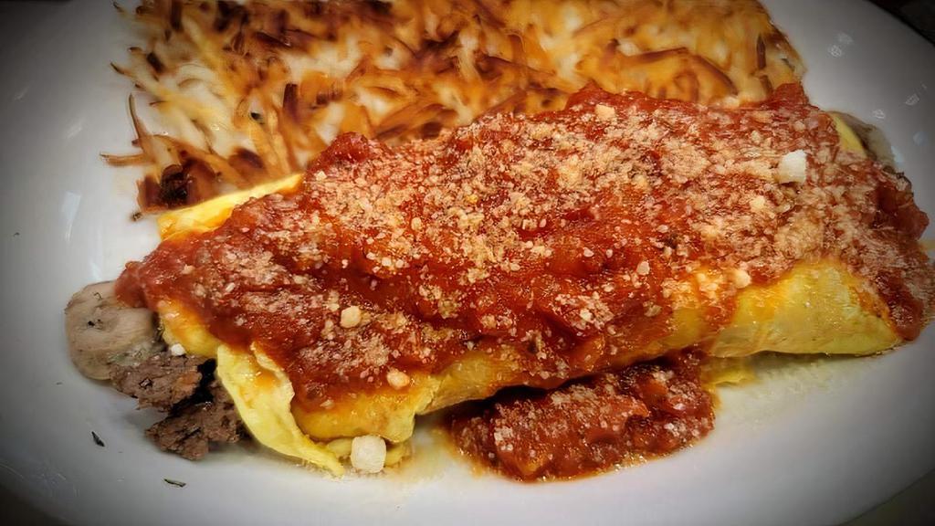 Italian Omelette · Ground beef, onions, Italian seasoning, Italian  sausage, mushrooms, spinach, scramble, marinara sauce and parmesan cheese.