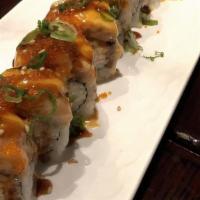 (Baked) Lion King Roll · Baked kani, avocado top with
salmon, spicy cream, unagi
sauce, sesame, tobiko and
green onion