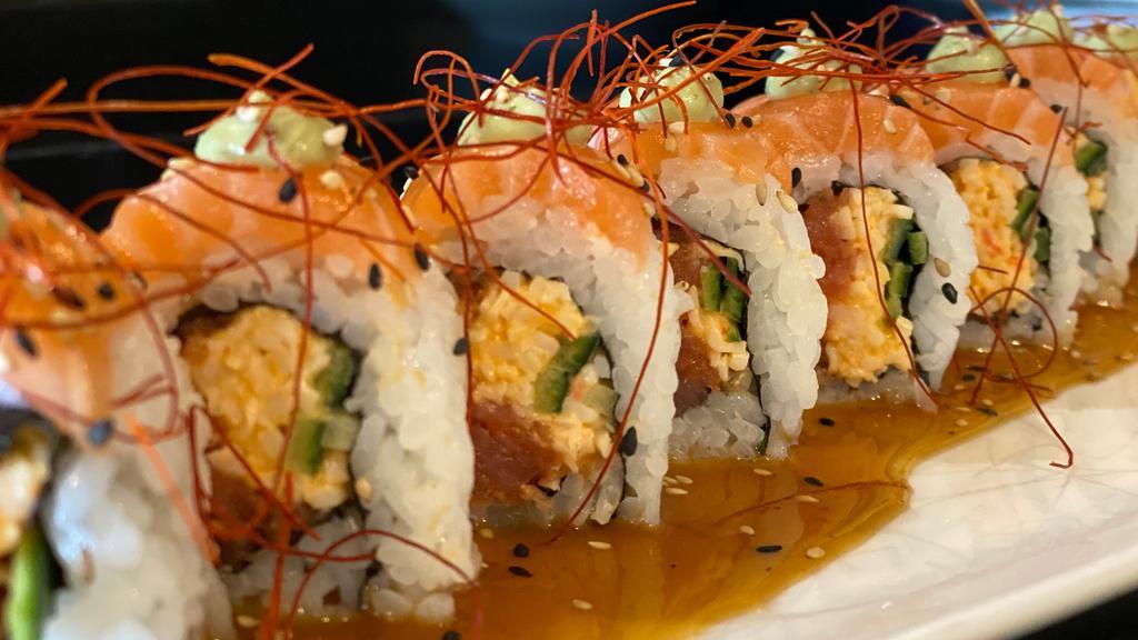 **Under the Sea · spicy crab, spicy tuna, cucumber, wrapped with salmon, topped with cilantro-avocado-wasabi sauce, soy vinaigrette, red chili strings