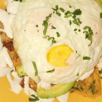 Chilaquiles · Fried eggs with tortilla chips, tomato sauce, bacon, pico de gallo, cheese, avocado, and sou...
