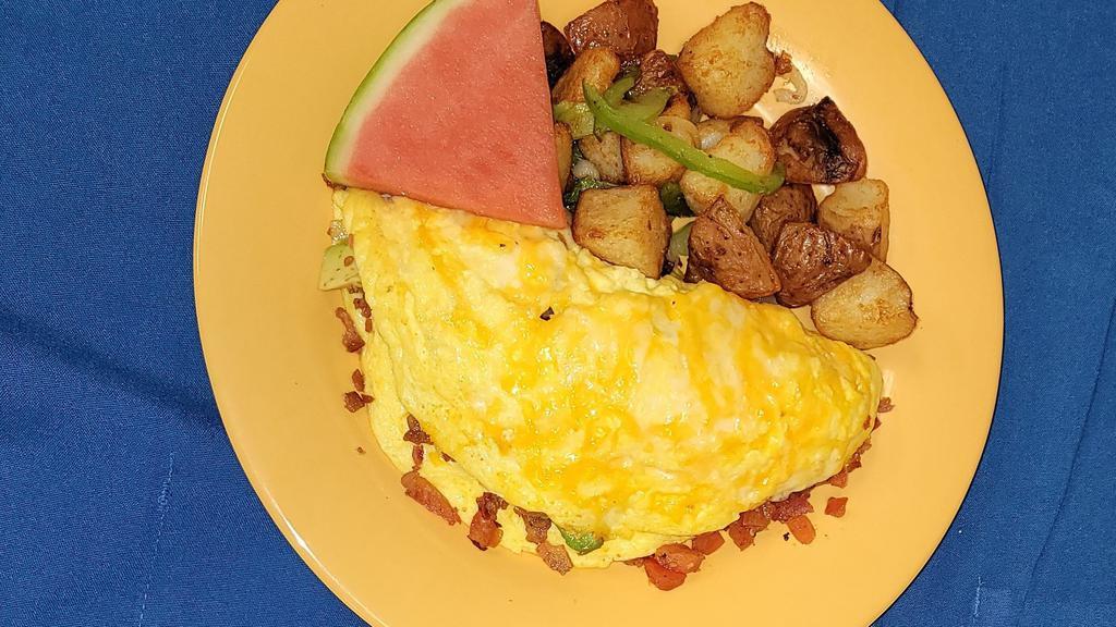 Bacon Omelet · Avocado, bacon, tomatoes, green onions and monterey jack cheese served with house potatoes or fresh fruits and toast.