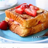 Banana Strawberries French Toast · French toast banana and strawberry served with butter and syrup.