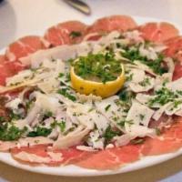 Carpaccio · Gluten-free. Thinly sliced beef with capers, onion, and parmesan
