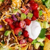 Traditional Taco Salad · Our traditional taco salad is served on a hot plate with cheese melted over your choice of g...
