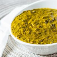 Palak Paneer · Chunks of homemade cheese cooked with fresh spinach herbs and spices.