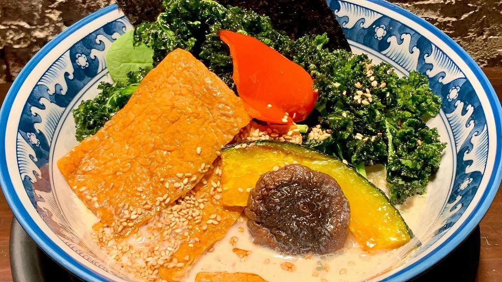 Creamy Ramen (Vegan) · Spinach vegan wheat noodle in a rich, sweet creamy vegan broth made with shiitake mushroom “dashi,” soy milk and sesame. Topped with inari (fried sweet tofu), crispy kale, acorn squash, shiitake mushrooms, nori (dried seaweed), sesame seeds and bell pepper.