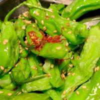 Shishito Peppers · Lightly fried and tossed in a savory soy glaze. 1 in 10 shishito can be extra spicy!