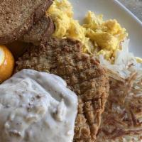 Chicken Fried Steak & Eggs · topped with country gravy and served with two organic eggs, choice of country potatoes or ha...