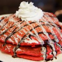 Red Velvet Pancakes with Cream Glaze · three pancakes with your choice of mixed berries or bananas, and topped with a cream cheese ...